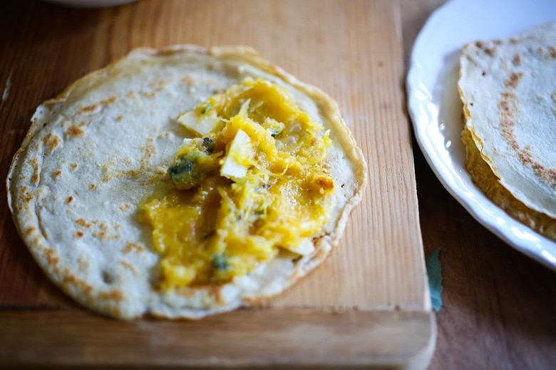 Savory Mushroom Crepes with Spaghetti Squash and Sage drizzled with Bechemal Sauce - a hearty cozy vegetarian dinner recipe, perfect for the colder months! #crepes #savorycrepes #mushroomcrepes #mushroomcrepes www.feastingathome.com