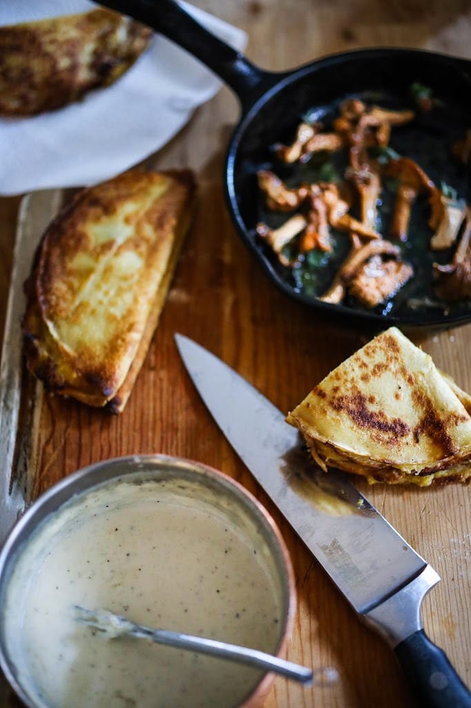 Savory Mushroom Crepes with Spaghetti Squash and Sage drizzled with Bechemal Sauce - a hearty cozy vegetarian dinner recipe, perfect for the colder months! #crepes #savorycrepes #mushroomcrepes #mushroomcrepes www.feastingathome.com