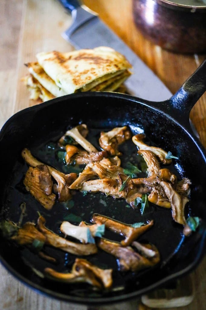 Savory Mushroom Crepes with Spaghetti Squash and Sage drizzled with Bechemal Sauce - a hearty cozy vegetarian dinner recipe, perfect for the colder months! #crepes #savorycrepes #mushroomcrepes #mushroomcrepes www.feastingathome.com