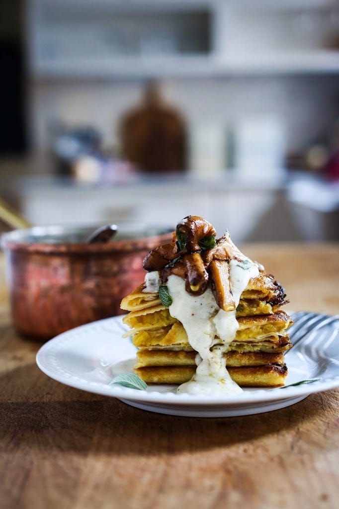 Savory Mushroom Crepes with Spaghetti Squash and Sage drizzled with Bechemal Sauce - a hearty cozy vegetarian dinner recipe, perfect for the colder months! #crepes #savorycrepes #mushroomcrepes #mushroomcrepes www.feastingathome.com