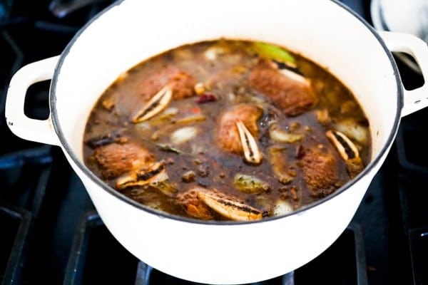 dutch oven with mexican short ribs in braising liquid.