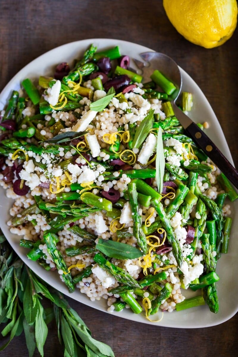 This Spring Asparagus Salad is so refreshing and delicious! Made with pearl couscous, asparagus, kalamata olives, pine nuts, feta, lemon zest, and mint tossed in a lemony dressing. A healthy delicious spring-inspired salad!
