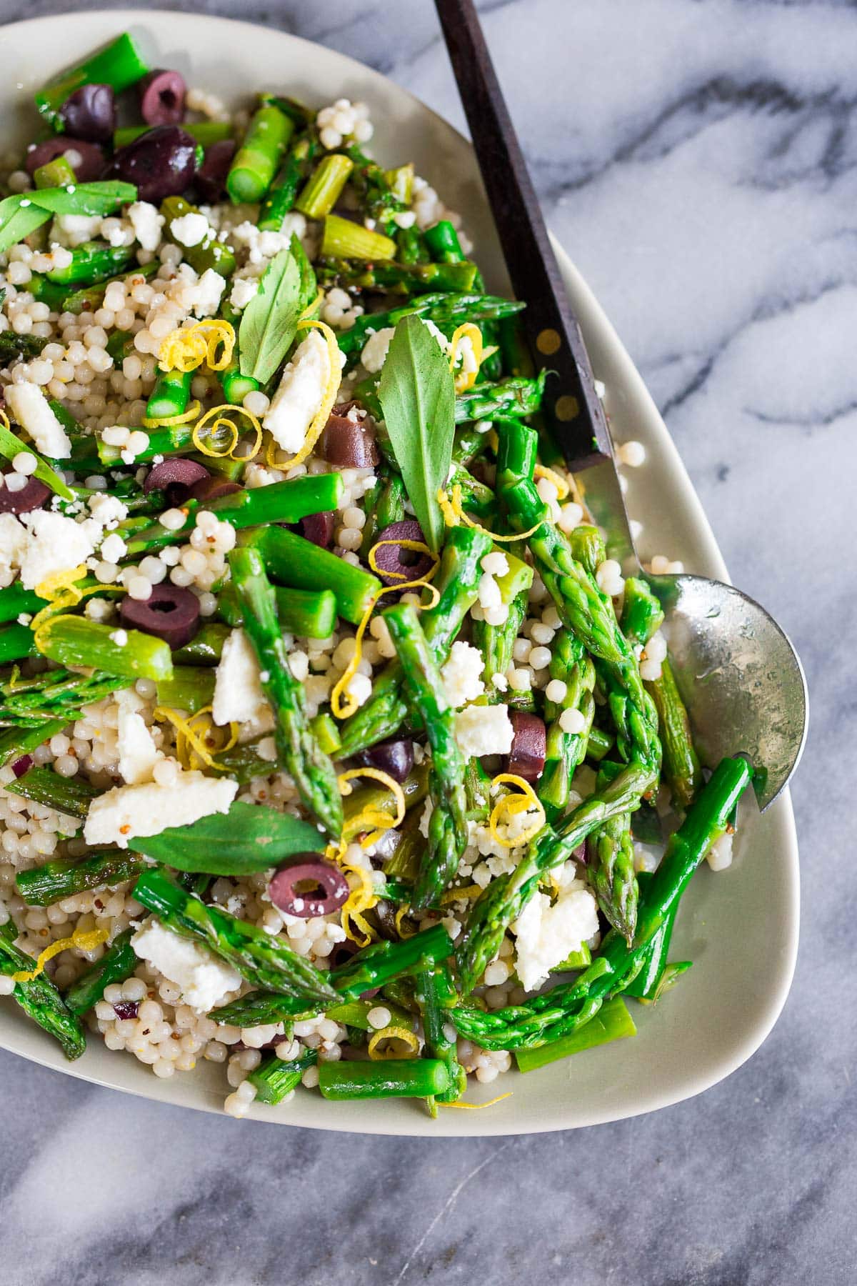 Greek-inspired Asparagus Salad recipe on an oval platter.