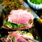 Herb-Crusted, Stuffed Leg of Lamb with flavorful Mint Gremolata, a step by step guide to an amazingly delicious holiday main course, baked over roasted vegetables.  #legoflamb #lamb #lambleg #easterdinner #easter #stuffedlamb #lambrecipes