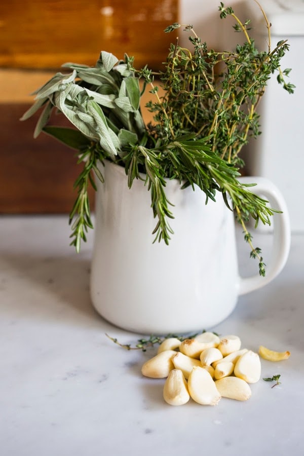 Herb-Crusted, Stuffed Leg of Lamb with flavorful Mint Gremolata, a step by step guide to an amazingly delicious holiday main course, baked over roasted vegetables.  #legoflamb #lamb #lambleg #easterdinner #easter #stuffedlamb #lambrecipes 