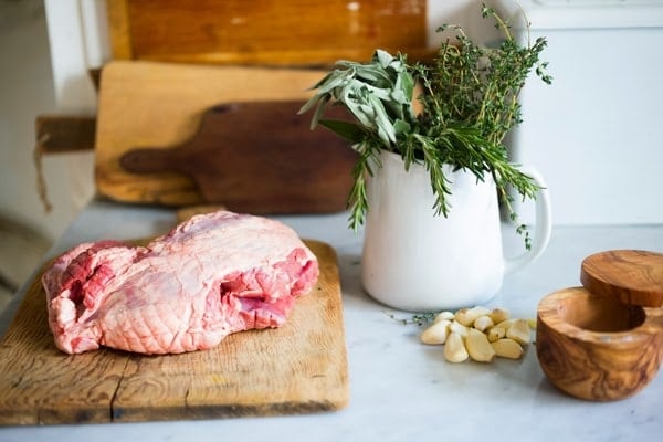 Herb-Crusted, Stuffed Leg of Lamb with flavorful Mint Gremolata, a step by step guide to an amazingly delicious holiday main course, baked over roasted vegetables.  #legoflamb #lamb #lambleg #easterdinner #easter #stuffedlamb #lambrecipes 