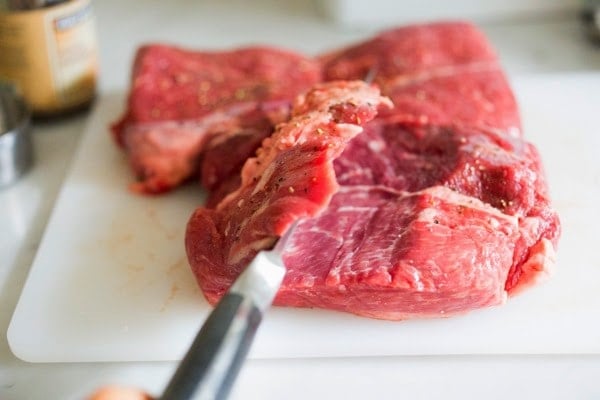 Herb-Crusted, Stuffed Leg of Lamb with flavorful Mint Gremolata, a step by step guide to an amazingly delicious holiday main course, baked over roasted vegetables.  #legoflamb #lamb #lambleg #easterdinner #easter #stuffedlamb #lambrecipes 