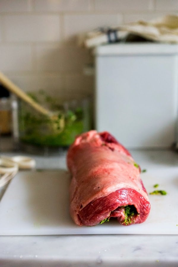 Herb-Crusted, Stuffed Leg of Lamb with flavorful Mint Gremolata, a step by step guide to an amazingly delicious holiday main course, baked over roasted vegetables.  #legoflamb #lamb #lambleg #easterdinner #easter #stuffedlamb #lambrecipes 