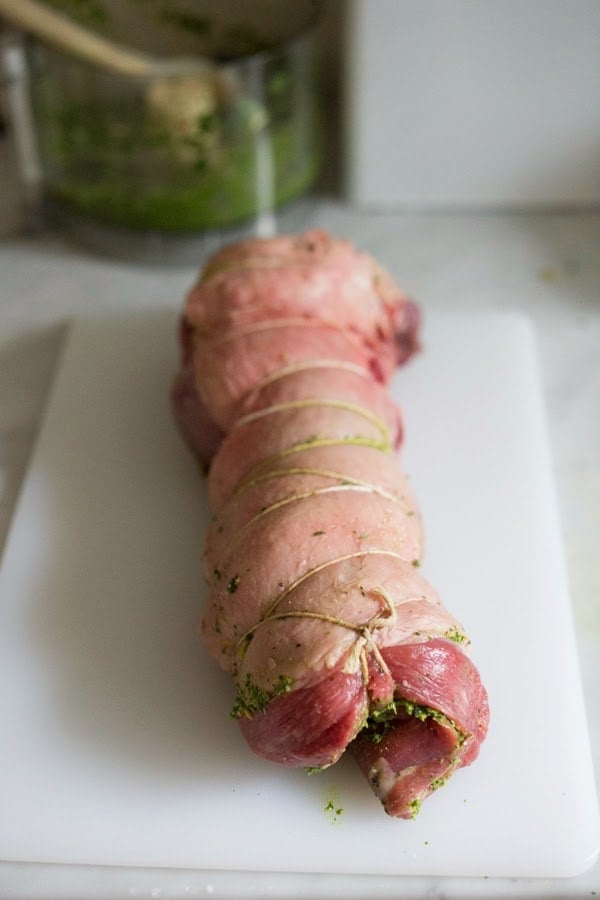 How to make the most delicious, Slow-Roasted Leg of Lamb with a flavorful herb crust and filling, roasted over vegetables and served with Mint Gremolata. A special dinner is worthy of your holiday table. #legoflamb #lamb #lambleg #easterdinner #easter #stuffedlamb #lambrecipes #lambroast #roastlegoflamb