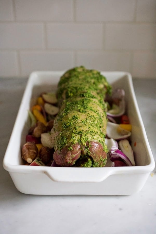 Herb Crusted and Stuffed Leg of Lamb with Mint Gremolata, a step by step guide to an amazingly delicious holiday main course, baked over roasted vegetables.