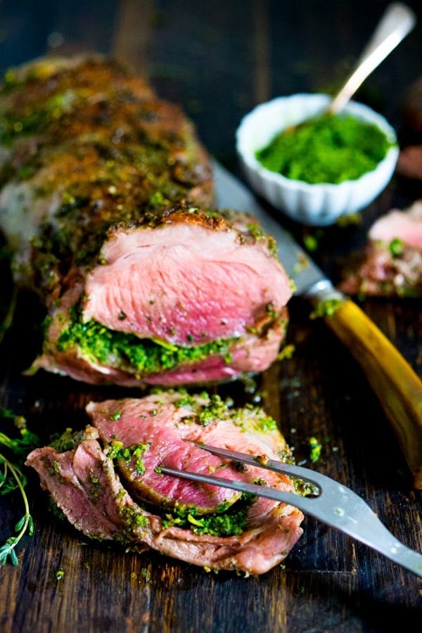 Roasted Leg of Lamb How to make the most delicious, Slow-Roasted Leg of Lamb with a flavorful herb crust and filling, roasted over vegetables and served with Mint Gremolata. A special dinner is worthy of your holiday table. #legoflamb #lamb #lambleg #easterdinner #easter #stuffedlamb #lambrecipes #lambroast #roastlegoflamb