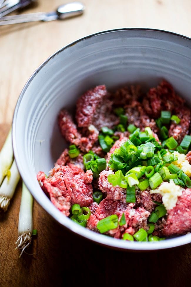 ground lamb with spices and onions in a bowl