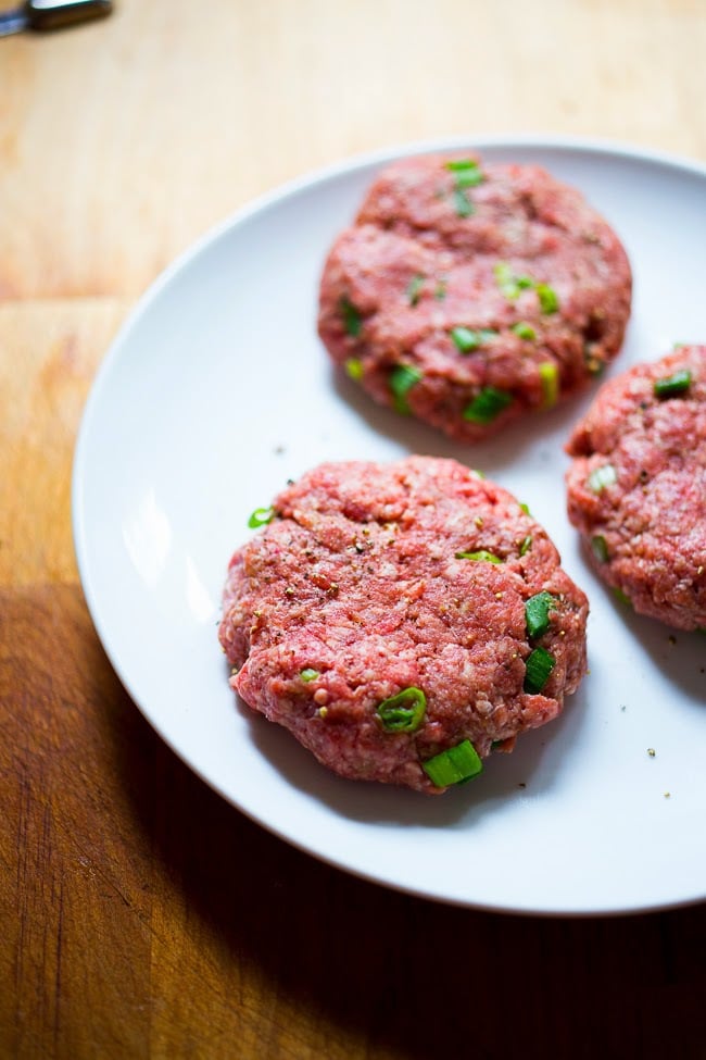 formed lamb burger patties on a plate