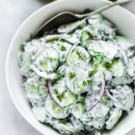 Turkish-inspired Creamy Cucumber Salad made with dill and mint in a creamy yogurt dressing. Cool and refreshing this herby lemony summer salad pairs well with grilled meats or fish, or falafels! 