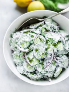 Turkish-inspired Creamy Cucumber Salad made with dill and mint in a creamy yogurt dressing. Cool and refreshing this herby lemony summer salad pairs well with grilled meats or fish, or falafels! 