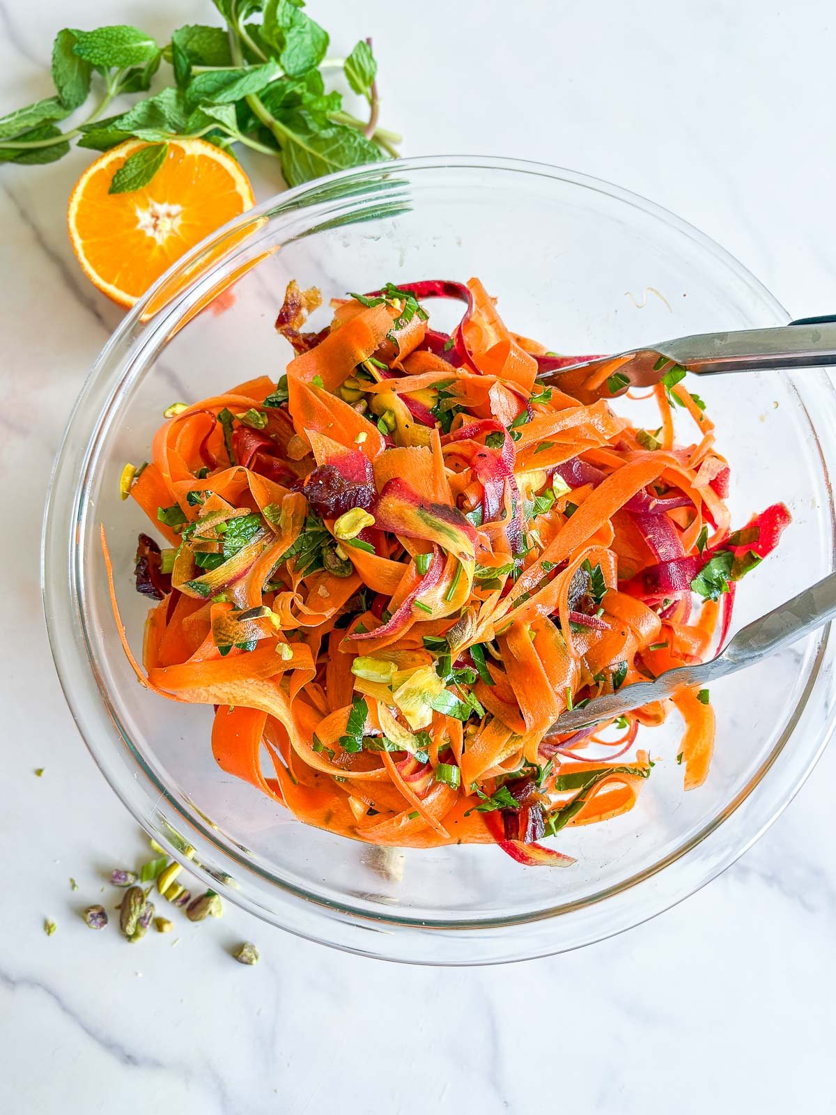 Tossing the carrot salad.