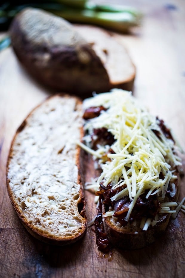 A delicious French Onion Grilled Cheese Sandwich with Caramelized onions, melty Gruyere and toasty bread. Serve with a salad and you have dinner!| www.feastingathome.com