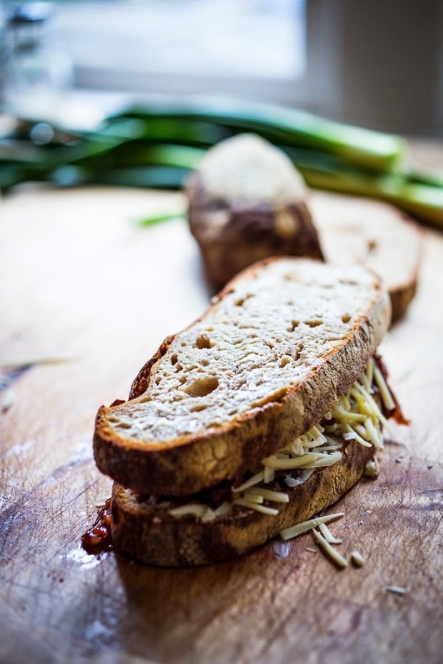A delicious French Onion Grilled Cheese Sandwich with Caramelized onions, melty Gruyere and toasty bread. Serve with a salad and you have dinner!| www.feastingathome.com
