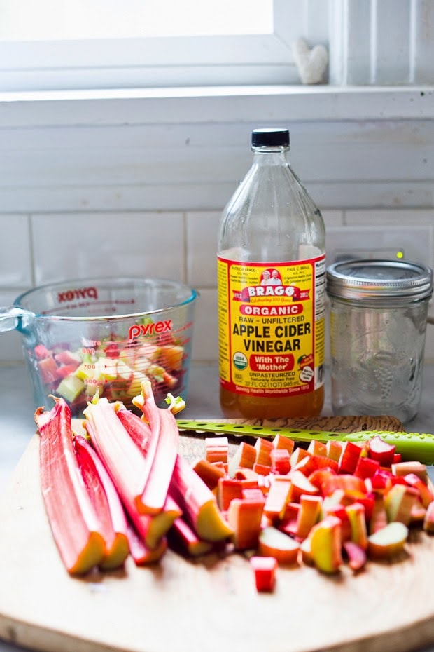 A simple delicious recipe for Rhubarb Shrub that can be used to make cocktails and mocktails. A great way to preserve the rhubarb growing in your garden! #shrub #rhubarb #rhubarbrecipes #mocktail | Feasting at Home