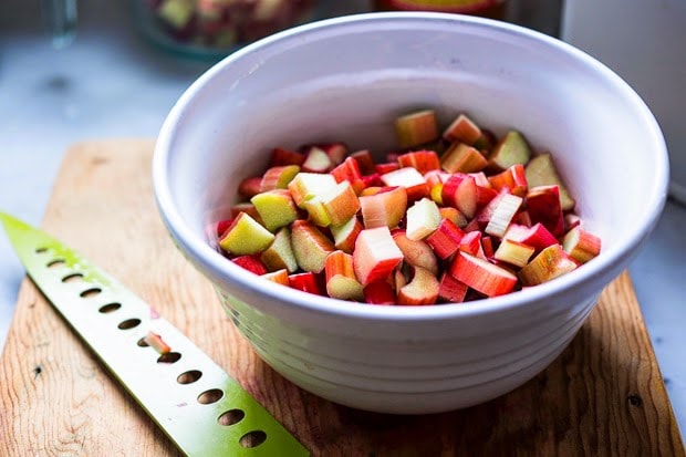 A simple delicious recipe for Rhubarb Shrub that can be used to make cocktails and mocktails. A great way to preserve the rhubarb growing in your garden! #shrub #rhubarb #rhubarbrecipes #mocktail | Feasting at Home