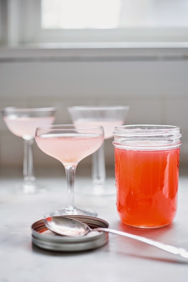 A simple delicious recipe for Rhubarb Shrub that can be used to make cocktails and mocktails. A great way to preserve the rhubarb growing in your garden! #shrub #rhubarb #rhubarbrecipes #mocktail | Feasting at Home