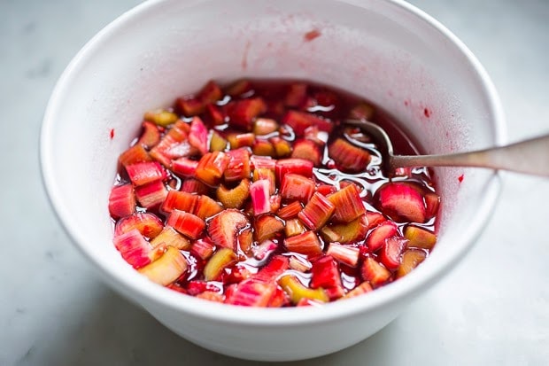 A simple delicious recipe for Rhubarb Shrub that can be used to make cocktails and mocktails. A great way to preserve the rhubarb growing in your garden! #shrub #rhubarb #rhubarbrecipes #mocktail | Feasting at Home