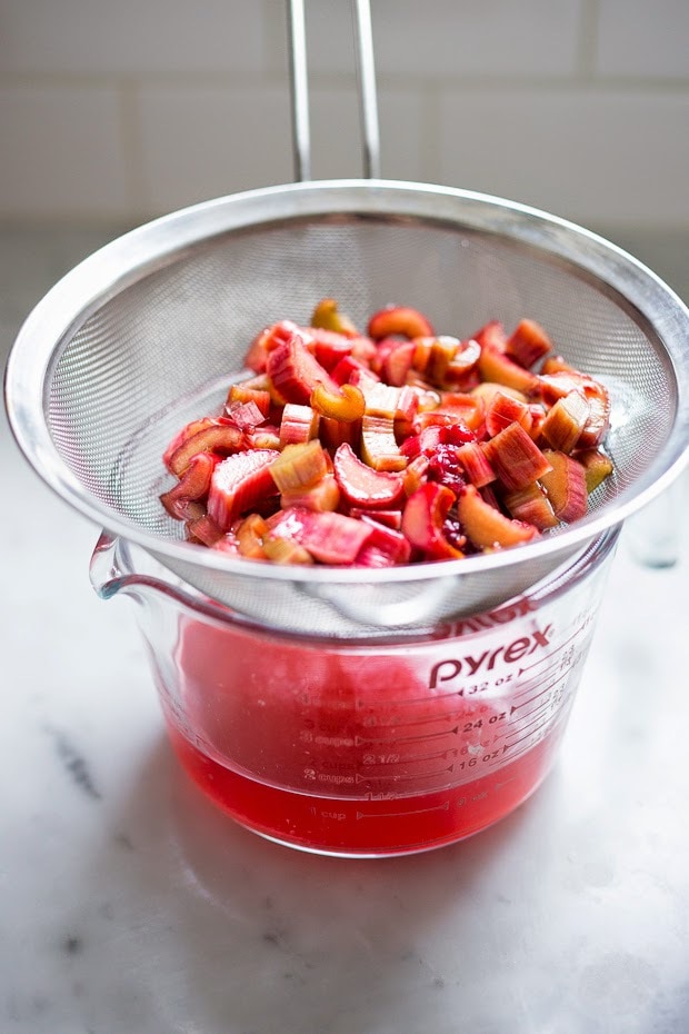 A simple delicious recipe for Rhubarb Shrub that can be used to make cocktails and mocktails. A great way to preserve the rhubarb growing in your garden! #shrub #rhubarb #rhubarbrecipes #mocktail | Feasting at Home