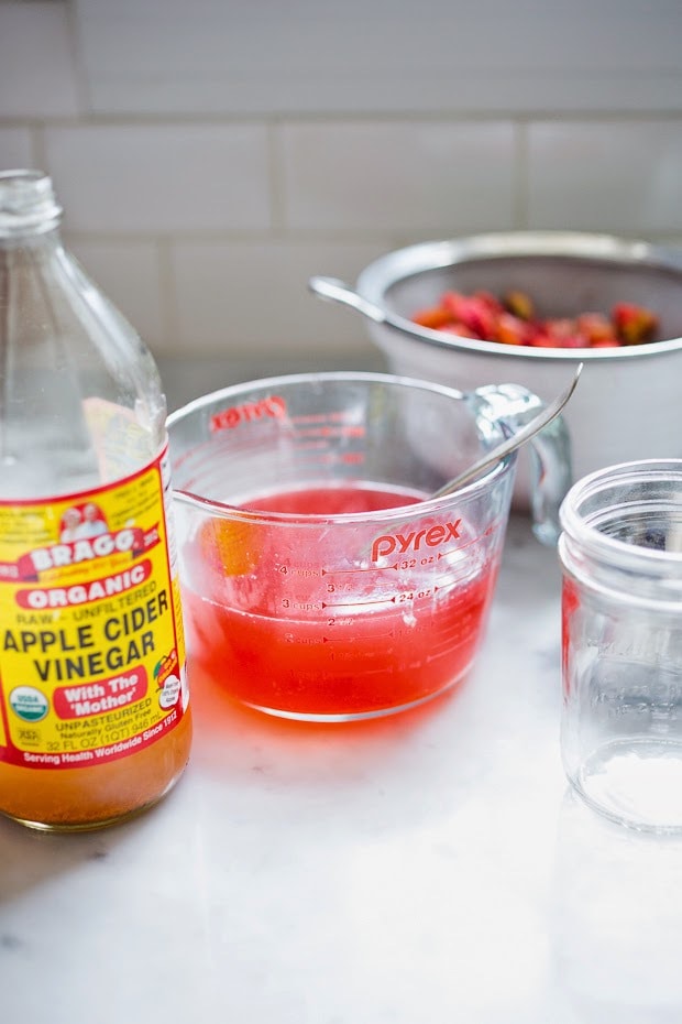 A simple delicious recipe for Rhubarb Shrub that can be used to make cocktails and mocktails. A great way to preserve the rhubarb growing in your garden! #shrub #rhubarb #rhubarbrecipes #mocktail | Feasting at Home