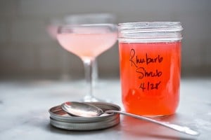 A simple delicious recipe for Rhubarb Shrub that can be used to make cocktails and mocktails. A great way to preserve the rhubarb growing in your garden! #shrub #rhubarb #rhubarbrecipes #mocktail | Feasting at Home