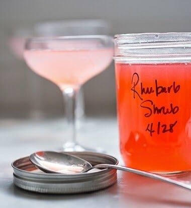 A simple delicious recipe for Rhubarb Shrub that can be used to make cocktails and mocktails. A great way to preserve the rhubarb growing in your garden! #shrub #rhubarb #rhubarbrecipes #mocktail | Feasting at Home