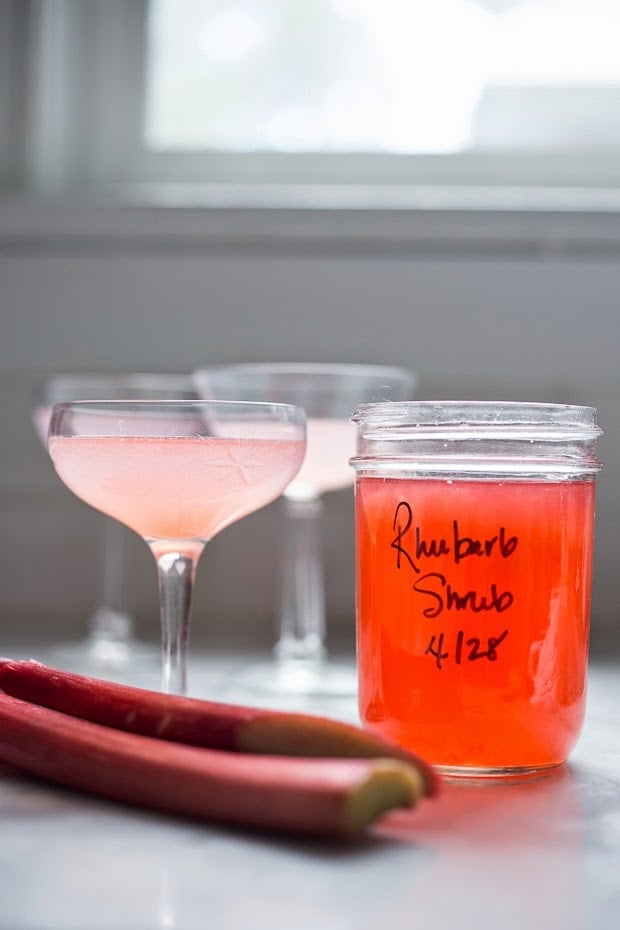 A simple delicious recipe for Rhubarb Shrub that can be used to make cocktails and mocktails. A great way to preserve the rhubarb growing in your garden! #shrub #rhubarb #rhubarbrecipes #mocktail | Feasting at Home