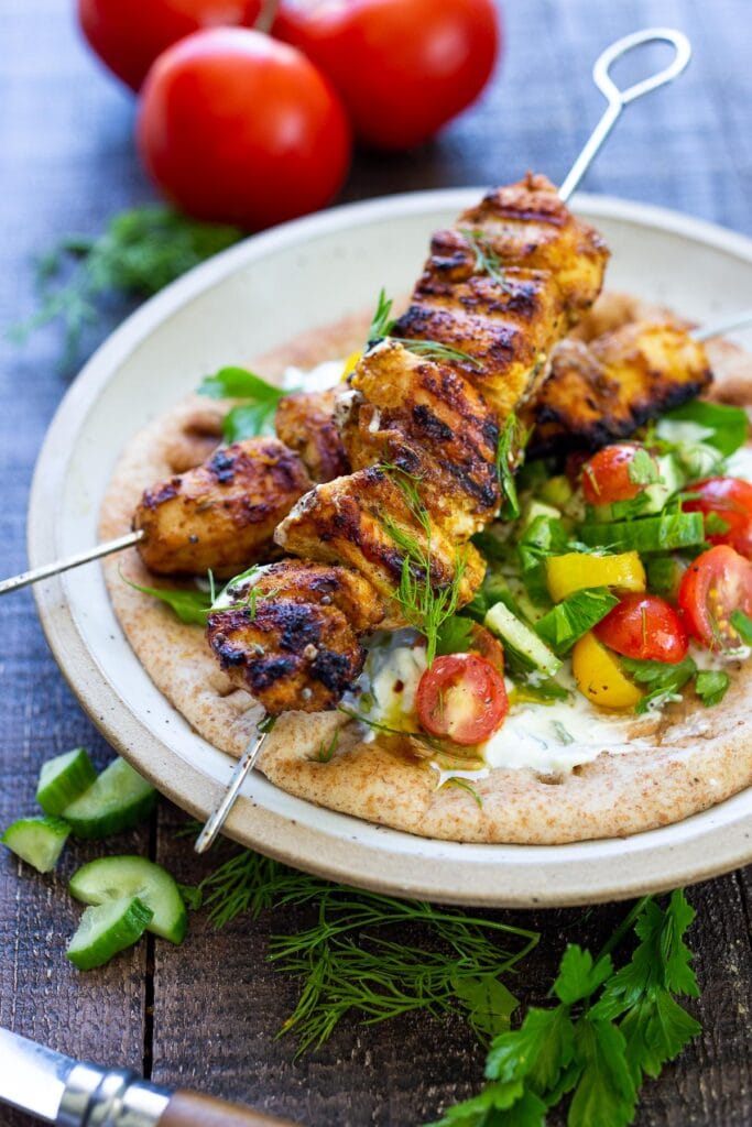  Grilled Chicken Shawarma is bursting with Middle Eastern Flavors! Serve it up with Israeli Salad and Basmati Rice (or Naan Bread) with a side of Tzatziki or Baba Ganoush! The perfect combination of flavors. No grill? Try this Baked Chicken Shawarma! 
