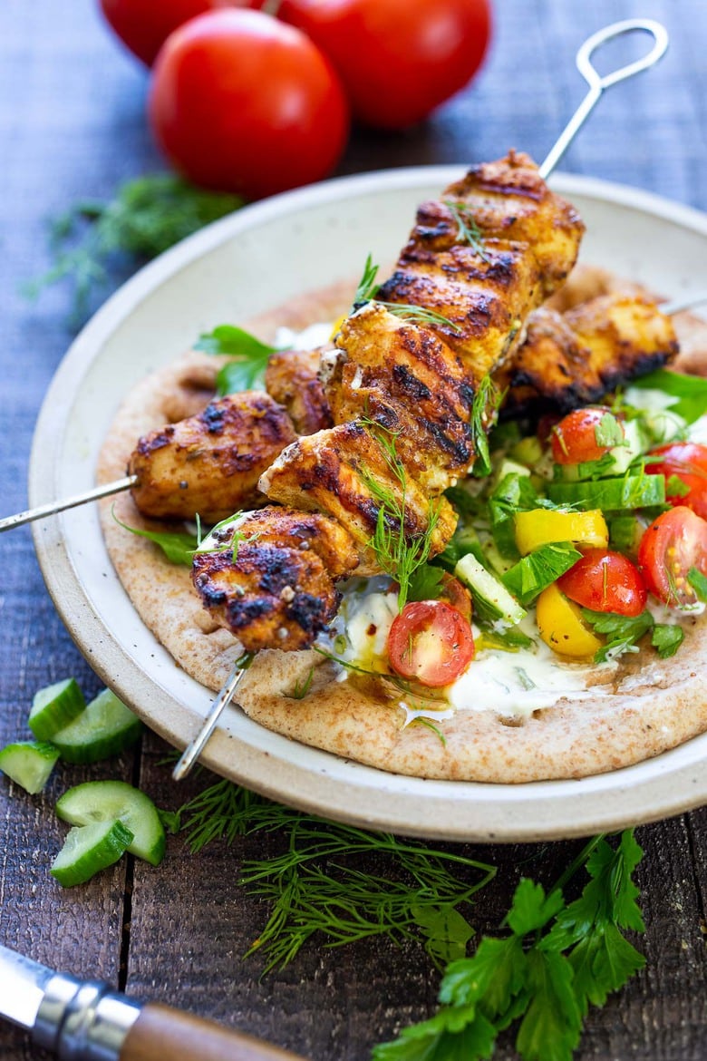  Grilled Chicken Shawarma skewers in a pita with tomato, cucumber, and tzatziki.