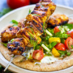 This EASY Grilled Chicken Shawarma recipe is bursting with Middle Eastern Flavors! Serve it as a wrap, in pita bread with tzatziki sauce and Israeli Salad. | #shawarma #chicken #chickenshawarma #shawarmawrap