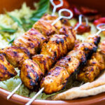 Grilled Tandoori Chicken- an easy authentic Indian recipe with a simple yogurt marinade using chicken thighs. Served with naan and Raita Sauce. #tandoorichicken #grilled #grilledchicken #indianrecipe