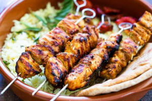 Grilled Tandoori Chicken- an easy authentic Indian recipe with a simple yogurt marinade using chicken thighs. Served with naan and Raita Sauce. #tandoorichicken #grilled #grilledchicken #indianrecipe