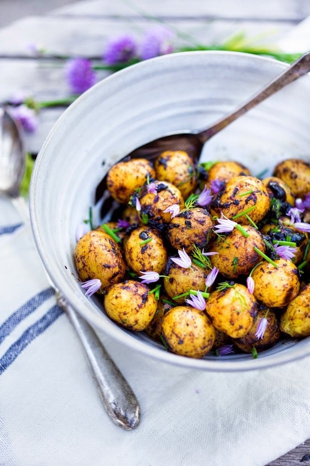 Grilled potato salad with a black garlic vinaigrette...a flavorful, lightened-up potato salad to serve alongside grilled meat or fish! Serve this warm or chilled.  #grilled #potatosalad #blackgarlic #healthypotatosalad #vegan