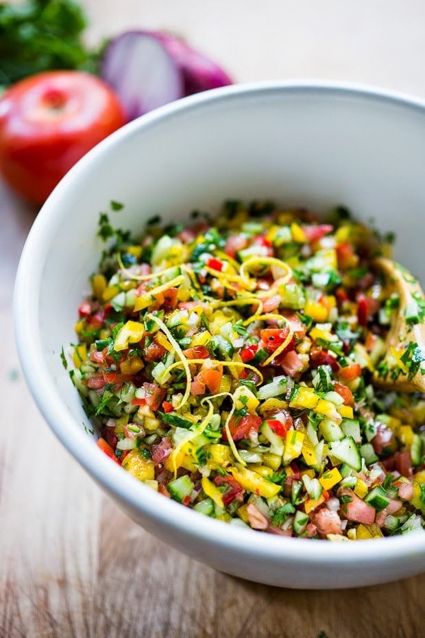 Israeli Salad REcipe made with finely chopped vegetables, fresh herbs, lemon and olive oil. Vegan and Gluten Free! | www.feastingathome.com #israelisalad #vegan #vegansalad #veggies #lunch #middleeastern #healthysalad