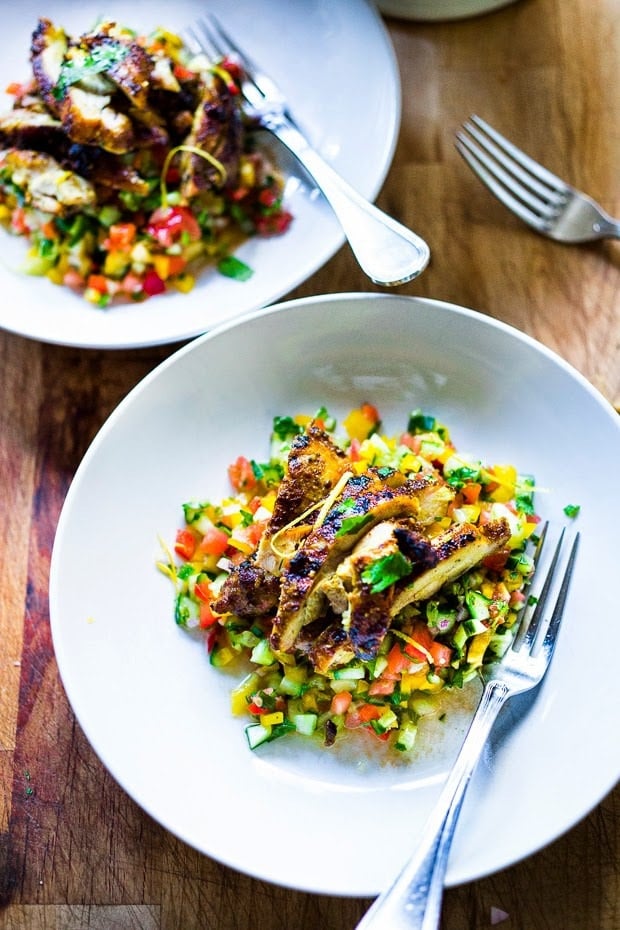 A simple & delicious recipe for Israeli Salad, made with finely chopped vegetables, fresh herbs, lemon and olive oil. Vegan and Gluten Free! | www.feastingathome.com