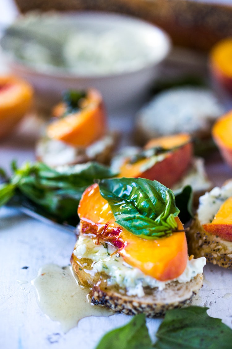 Peach Brushetta with goat cheese, basil and infused honey...a simple delicious appetizer you can make in minutes!| #peach #peachrecipes #bruschetta #peachbruschetta www.feastingathome.com