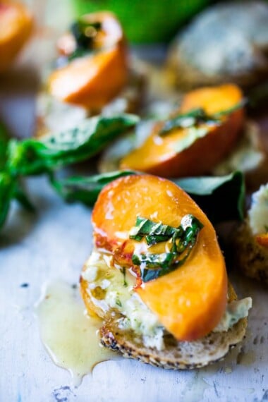 Peach Brushetta with goat cheese, basil and infused honey...a simple delicious appetizer you can make in minutes!| #peach #peachrecipes #bruschetta #peachbruschetta www.feastingathome.com