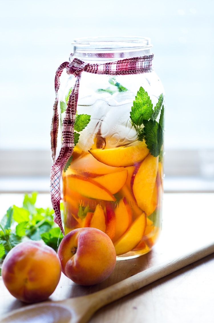 Simple Refreshing Peach Sangria ...a delicious summer cocktail made with white wine and Elder flower liquor (or syrup) that can be made ahead. Perfect for a crowd!  #peachsangria #peach #sangria | www.feastingathome.com