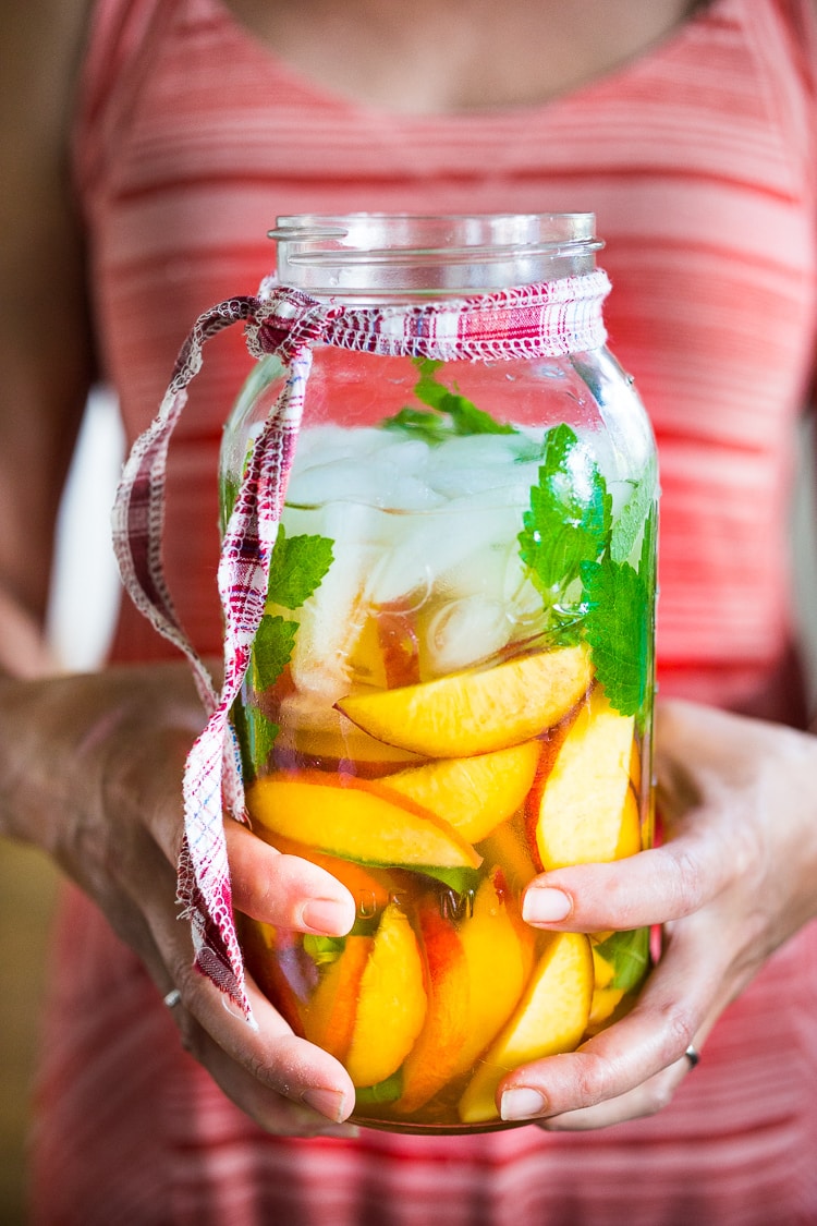 Peach Sangria ...a delicious summer drink made with white wine and Elder flower liquor (or syrup) that can be made ahead. Perfect for a crowd!  #peachsangria #peach #sangria | www.feastingathome.com