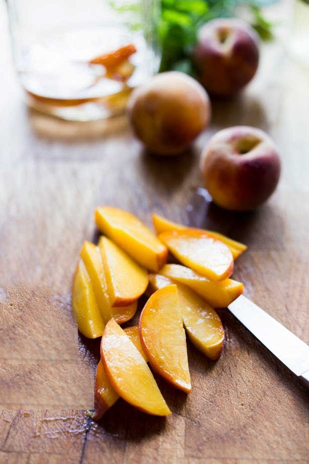 Simple Refreshing Peach Sangria ...a delicious summer drink made with white wine and Elder flower liquor (or syrup) that can be made ahead. Perfect for a crowd!  #peachsangria #peach #sangria | www.feastingathome.com