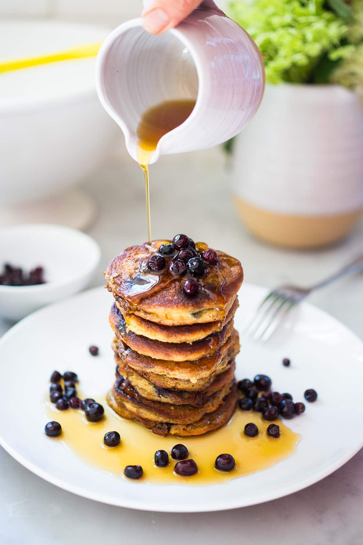 Almond Flour Pancakes with maple syrup and fresh berries- a delicious, one bowl, grain-free, gluten-free, paleo recipe for our favorite breakfast!