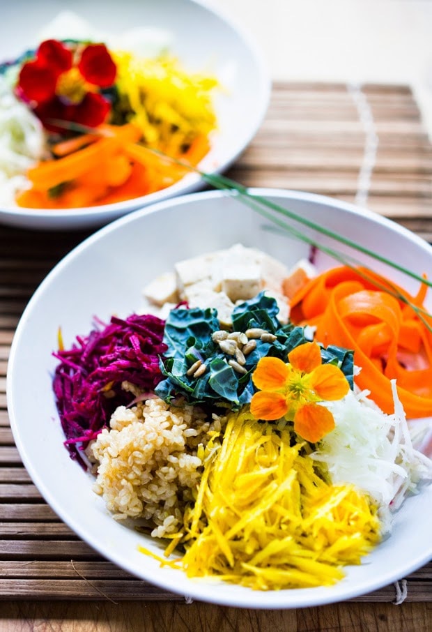 Vegan Sunshine Bowl w/ fresh crunchy veggies- grated beets, carrots, kohlrabi, sunchokes, radish & jicama with nutty brown rice and sunflower tahini sauce. | www.feastingathome.com