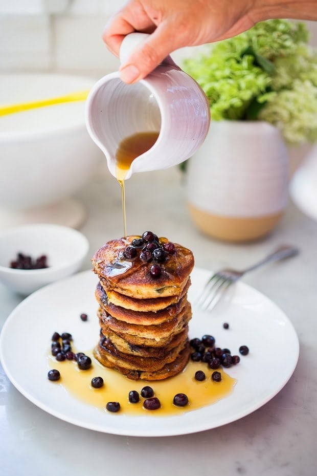 Almond Flour Pancakes with maple syrup and fresh berries-  a delicious, one bowl, grain-free, gluten-free, paleo recipe for our favorite breakfast! #pancakes #almondflour #paleopanckes #huckleberries 