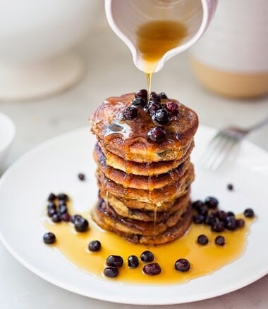 EASY Almond Flour Pancakes with fresh huckleberries (or sub your favorite summer berry) - a delicious, low-carb, gluten-free, paleo recipe for our favorite breakfast! #pancakes #almondflour #paleopanckes #huckleberries