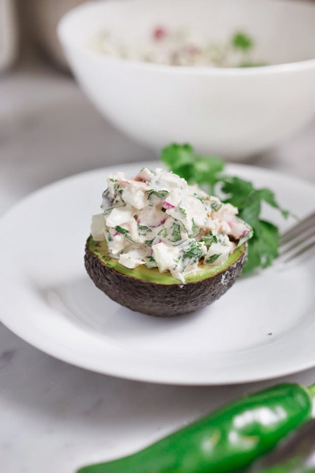 Mexican Tuna Salad Stuffed Avocado with radish, cucumber, cilantro and jalapeño, a quick, healthy 5 minute meal! | www.feastingathome.com