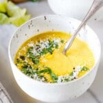 This easy corn soup recipe is the best summer tradition! Use fresh corn or frozen corn; it's creamy, delicious, and vegetarian. Topped with cilantro, cotija and lime.